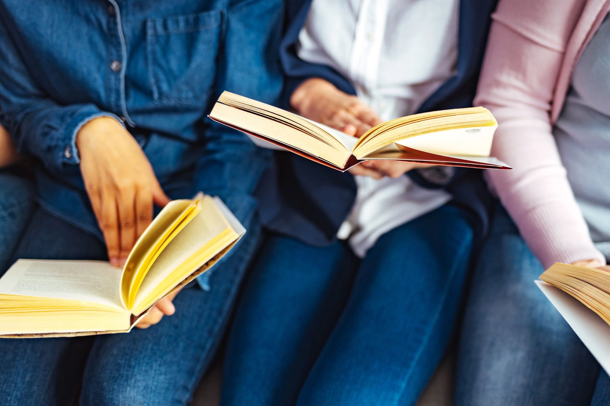 People reading and discussing stories together at a table